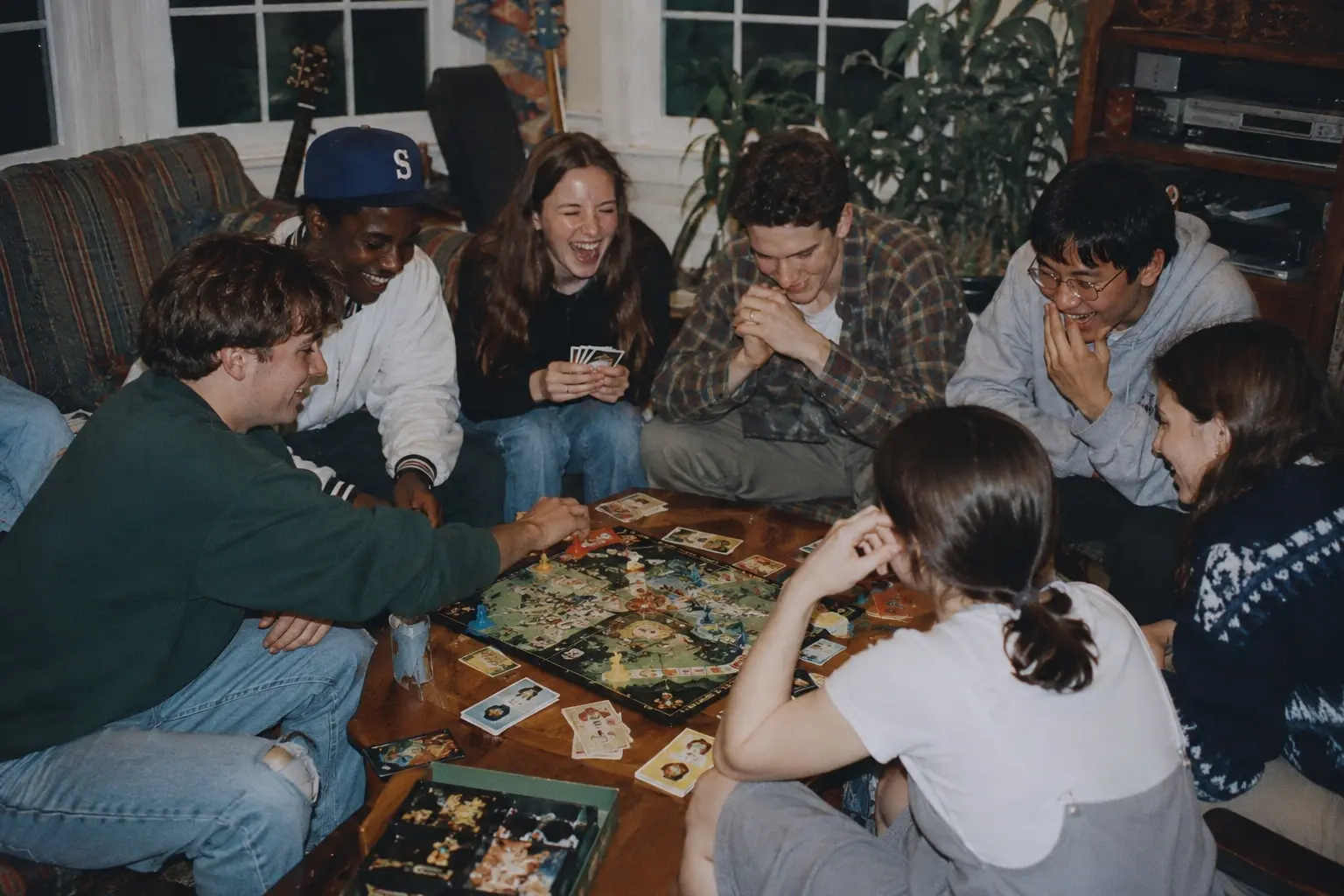 Friends laughing and playing a board game together in a cozy living room.