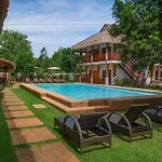 Tropical Resort-Style Swimming Pool with Thatched Pavilion