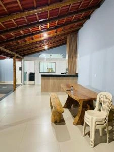 Spacious living area with wooden ceiling, dining table, and bar counter.