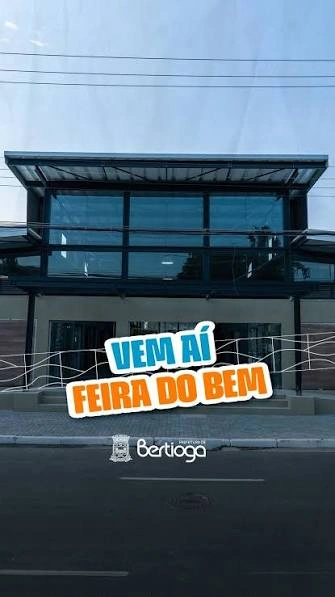 A vertical promotional graphic featuring the text "VEM AÍ FEIRA DO BEM" in bold, colorful lettering overlaid on a photo of a modern building facade.